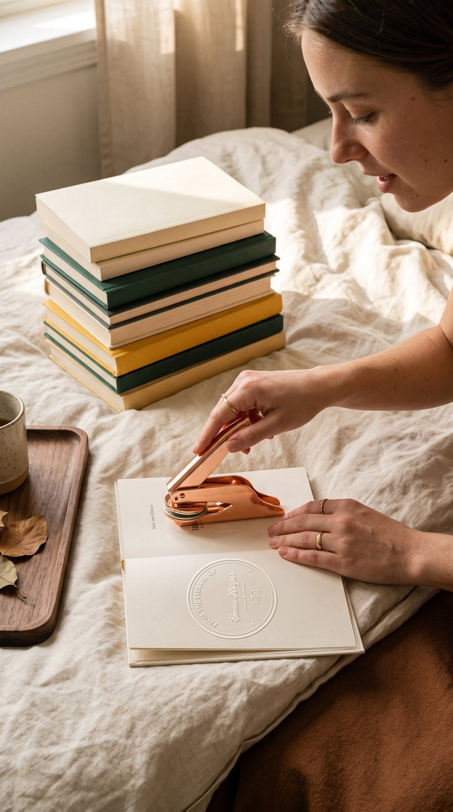 Embossing a stack of paperbacks with a rose gold embosser