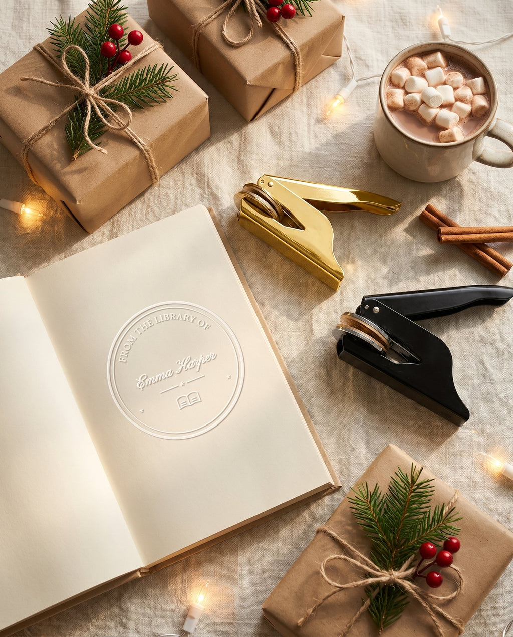 Gold and black book embossers with an embossed book and wrapped Christmas gifts