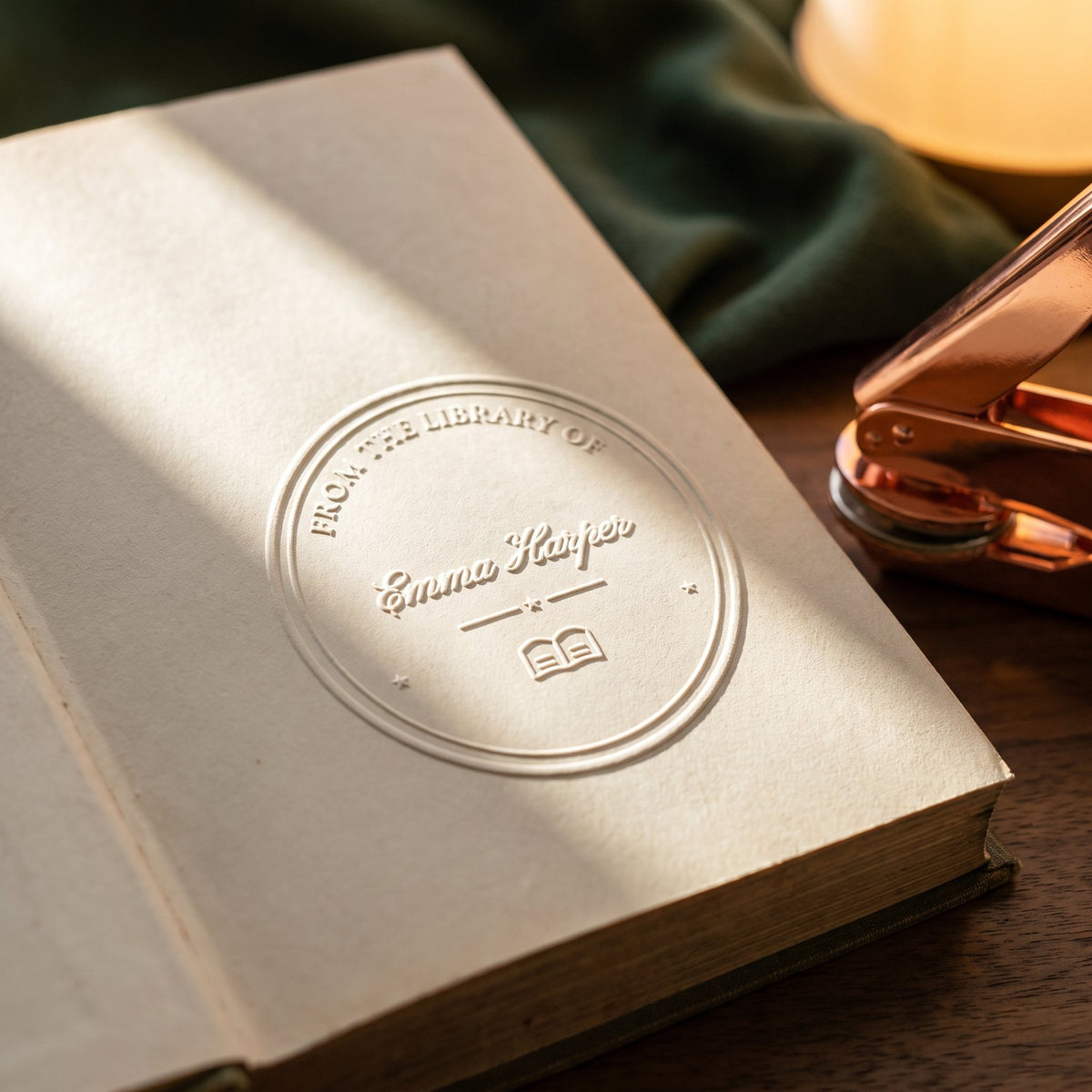 Close-up of a raised seal reading From the library of Emma Harper on a book page